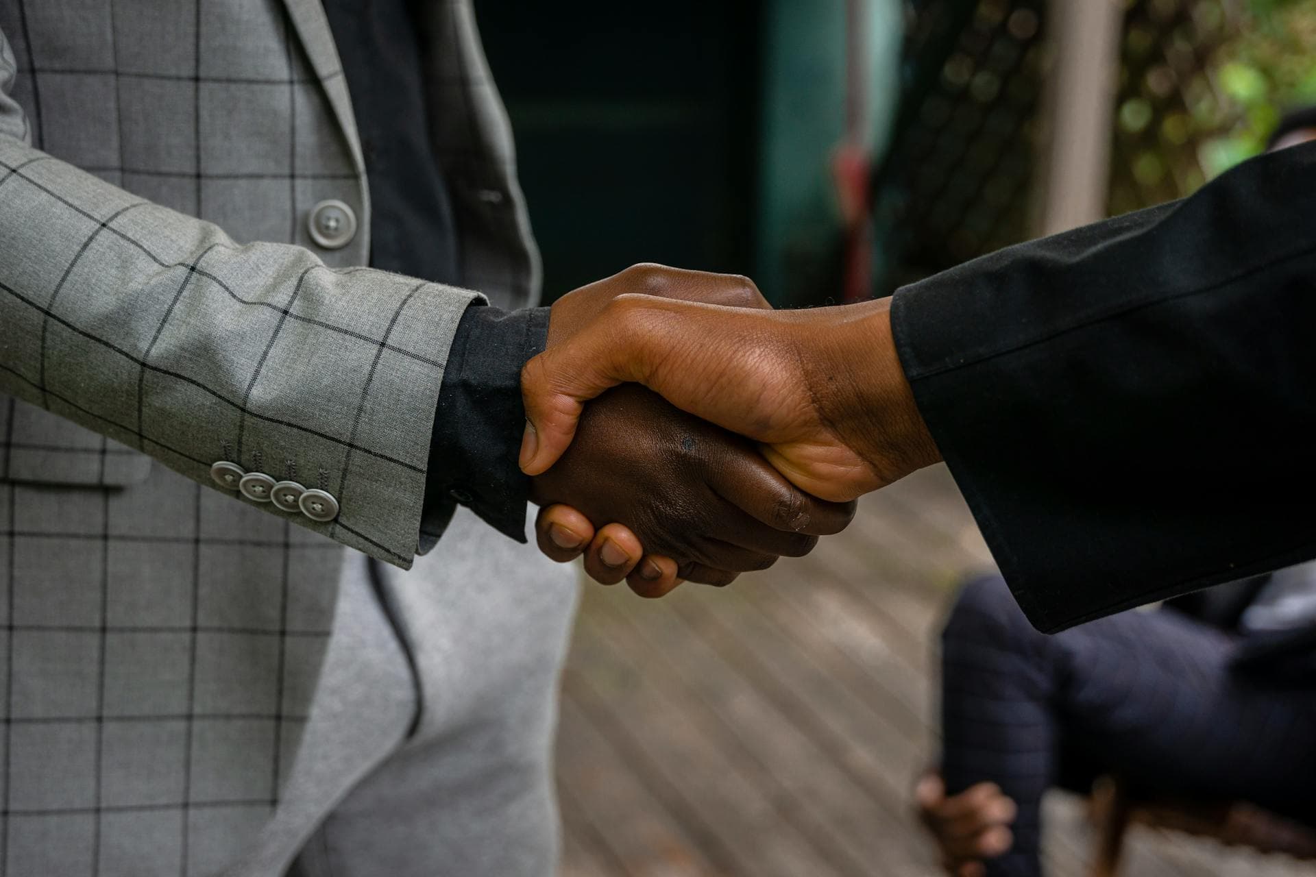 Close-up of two professionals shaking hands, symbolizing success and partnership